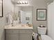 Neutral toned bathroom featuring decorative mirror, modern vanity, and beautiful wall art at 4298 Kingston Gate Cv, Chamblee, GA 30341