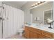 Bathroom with single vanity, oak cabinets, and shower with curtain at 4298 Kingston Gate Cv, Chamblee, GA 30341