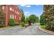 Gated brick entrance of a residential community with lush landscaping on a sunny day at 4298 Kingston Gate Cv, Chamblee, GA 30341