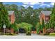 Beautiful brick community entrance with mature trees and landscaping at 4298 Kingston Gate Cv, Chamblee, GA 30341