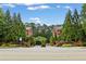 A gated townhome community with mature trees, well-maintained landscaping and brick signage at 4298 Kingston Gate Cv, Chamblee, GA 30341
