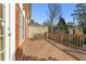Outdoor deck with ample space for seating, bordered by brick wall and wood railing at 4298 Kingston Gate Cv, Chamblee, GA 30341
