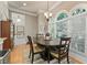 Bright dining room with dark wood table, chandelier, large windows and hardwood floors at 4298 Kingston Gate Cv, Chamblee, GA 30341