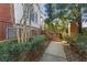 Townhouse exterior features a private entrance with brick and lush greenery at 4298 Kingston Gate Cv, Chamblee, GA 30341
