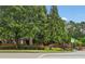 Charming Kingston Gate community entrance featuring brick signage, lush landscaping, and mature trees for a welcoming feel at 4298 Kingston Gate Cv, Chamblee, GA 30341