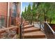 Brick steps with iron railings lead to the home's front entrance, surrounded by mature landscaping at 4298 Kingston Gate Cv, Chamblee, GA 30341