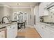 Bright kitchen area featuring white cabinets, granite countertops, and adjacent breakfast nook with large windows at 4298 Kingston Gate Cv, Chamblee, GA 30341