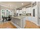 Bright eat-in kitchen with an island, granite countertops, stainless steel appliances and stylish light fixture at 4298 Kingston Gate Cv, Chamblee, GA 30341