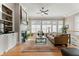 Inviting living room with a fireplace, built-in bookshelves, and large windows overlooking the backyard at 4298 Kingston Gate Cv, Chamblee, GA 30341