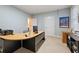 Office with L-shaped desk, bright neutral walls, and light from a window and interior lighting at 4298 Kingston Gate Cv, Chamblee, GA 30341