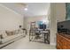 Comfortable office featuring sofa, modern desk, shelves, and hardwood dresser at 4298 Kingston Gate Cv, Chamblee, GA 30341