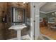 Stylish powder room with pedestal sink and patterned wallpaper at 4298 Kingston Gate Cv, Chamblee, GA 30341