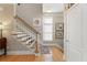 Elegant staircase featuring hardwood treads, white risers, a wood handrail, and stylish wall decor at 4298 Kingston Gate Cv, Chamblee, GA 30341