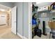 Well-organized storage closet or pantry with shelving units, storage containers, and carpeted floor at 4298 Kingston Gate Cv, Chamblee, GA 30341