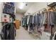 Large walk-in closet with ample storage space and organized hanging racks and shelves at 4298 Kingston Gate Cv, Chamblee, GA 30341