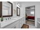 Elegant bathroom with double sinks, white cabinetry, and view to a bedroom at 4565 Sims Park Ovlk, Suwanee, GA 30024