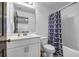 Bright bathroom with single sink vanity, white tiled shower and modern patterned shower curtain at 4565 Sims Park Ovlk, Suwanee, GA 30024