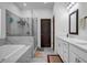 Luxurious bathroom with a soaking tub, glass-enclosed shower, and elegant marble accents at 4565 Sims Park Ovlk, Suwanee, GA 30024