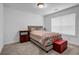 Cozy bedroom with a window, carpet, and simple furnishings at 4565 Sims Park Ovlk, Suwanee, GA 30024
