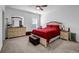 Bright bedroom featuring a ceiling fan, carpet, and a large window at 4565 Sims Park Ovlk, Suwanee, GA 30024