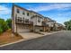 View of townhome exteriors with garages and wooden decks, showcasing the community's design at 4565 Sims Park Ovlk, Suwanee, GA 30024