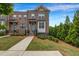 Brick townhome with manicured lawn, landscaping and a walkway leading to the front door at 4565 Sims Park Ovlk, Suwanee, GA 30024