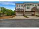 Townhome exterior showcasing a two-story facade, individual garages, and private wooden decks at 4565 Sims Park Ovlk, Suwanee, GA 30024