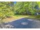 The backyard is shaded with mature trees and has a paved area at 7577 Haley Dr, Jonesboro, GA 30236