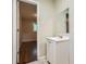 Updated bathroom featuring a white vanity and view to adjoining bedroom at 7577 Haley Dr, Jonesboro, GA 30236