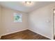 Bedroom with hardwood floors, neutral walls, and window views at 7577 Haley Dr, Jonesboro, GA 30236