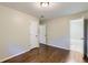 Bedroom featuring hardwood floors, neutral walls and open door to bathroom at 7577 Haley Dr, Jonesboro, GA 30236