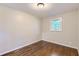 This bedroom features hardwood floors and a bright window at 7577 Haley Dr, Jonesboro, GA 30236