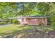 Charming brick home with a well-maintained lawn and mature trees, offering a serene curb appeal at 7577 Haley Dr, Jonesboro, GA 30236
