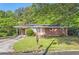Inviting single-story brick home with a covered carport, lush greenery, and a classic mailbox at 7577 Haley Dr, Jonesboro, GA 30236