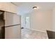 Bright kitchen showcasing a stainless steel refrigerator, tile flooring, and ample space for dining at 7577 Haley Dr, Jonesboro, GA 30236