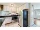 Efficient kitchen with white cabinets, stainless steel appliances, and easy-to-clean tile floors at 7577 Haley Dr, Jonesboro, GA 30236