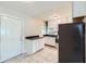 Functional kitchen featuring white cabinetry, dark countertops, and tile flooring for a clean aesthetic at 7577 Haley Dr, Jonesboro, GA 30236