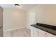 Cozy kitchen area with tile floors, dark countertop, and plenty of cabinet space at 7577 Haley Dr, Jonesboro, GA 30236