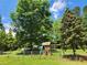 Spacious backyard with mature trees and a fun playset for children at 350 Lakeview Dr, Brooks, GA 30205