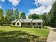 Inviting one-story home with a well-kept lawn, accented by lush landscaping at 350 Lakeview Dr, Brooks, GA 30205