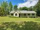 Charming single-story home with a manicured lawn and a welcoming front porch at 350 Lakeview Dr, Brooks, GA 30205