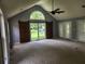 Bright living room with vaulted ceiling, large window, and stylish barn door at 350 Lakeview Dr, Brooks, GA 30205