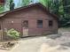 Exterior view of a rustic cabin home featuring natural wood siding at 418 Honey Suckle Ln, Stockbridge, GA 30281