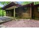 Rustic cabin featuring a quaint porch and natural surroundings at 418 Honey Suckle Ln, Stockbridge, GA 30281
