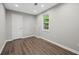 Clean bedroom with hard wood floors, a window, and a door, offering a simple, comfortable private space at 4305 Chesapeake Trce, Acworth, GA 30101