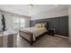 Comfortable bedroom featuring stylish accent wall, tray ceiling, and soft carpet at 4305 Chesapeake Trce, Acworth, GA 30101