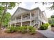 Stunning two-story clubhouse with wraparound porch, white columns, and manicured landscaping at 4305 Chesapeake Trce, Acworth, GA 30101