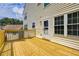 Spacious wood deck, perfect for entertaining and relaxing, with white door and trim under a blue sky at 4305 Chesapeake Trce, Acworth, GA 30101