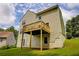 Two-story home featuring a wood deck, siding, and lush green lawn under a partly cloudy sky at 4305 Chesapeake Trce, Acworth, GA 30101