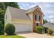 Charming two-story home with brick facade, manicured landscaping, and attached two-car garage at 4305 Chesapeake Trce, Acworth, GA 30101